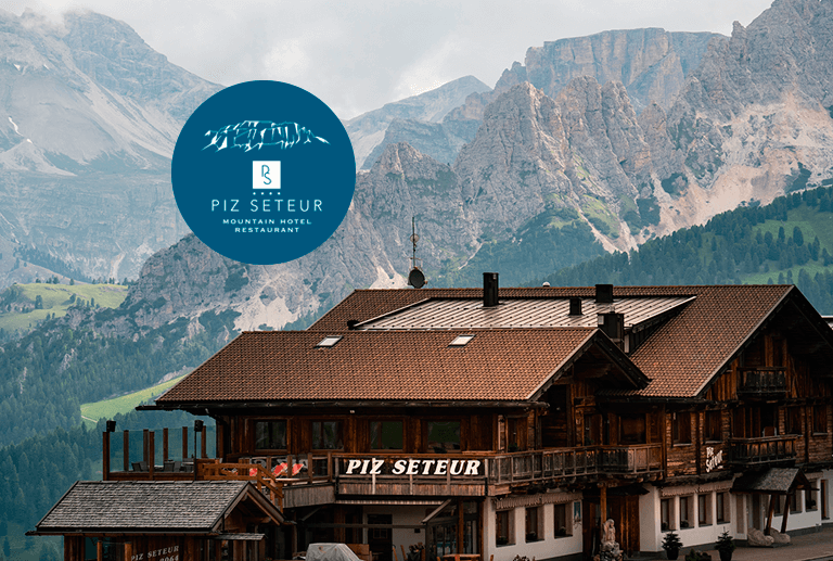 a building with mountains in the background